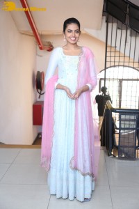 Shivani Rajashekar poses in a light colored Salwar Kameez dress