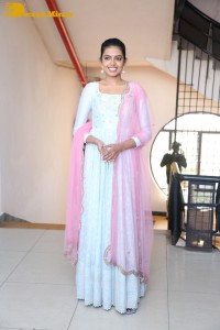 Shivani Rajashekar poses in a light colored Salwar Kameez dress