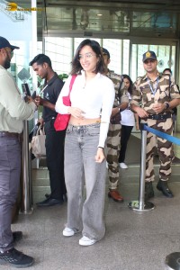 actress Shraddha Kapoor in a white top and grey jeans at airport