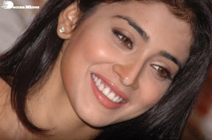 Shriya Saran in a golden color dress promoting her film