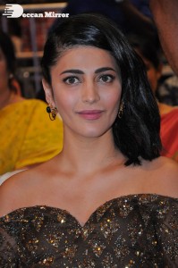 Shruti Haasan in a golden brown dress at a movie function
