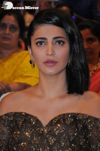 Shruti Haasan in a golden brown dress at a movie function