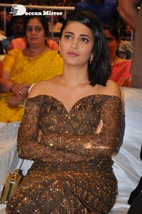 Shruti Haasan in a golden brown dress at a movie function