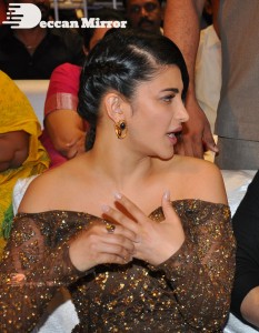 Shruti Haasan in a golden brown dress at a movie function