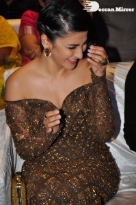 Shruti Haasan in a golden brown dress at a movie function