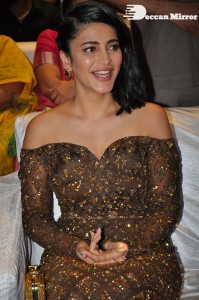 Shruti Haasan in a golden brown dress at a movie function