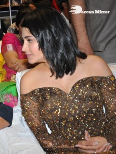Shruti Haasan in a golden brown dress at a movie function