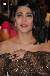 Shruti Haasan in a golden brown dress at a movie function