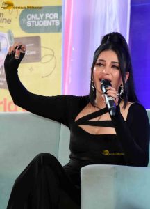 actress Shruti Haasan ravishing in a black dress speaking at an event