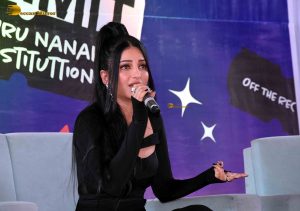 actress Shruti Haasan ravishing in a black dress speaking at an event