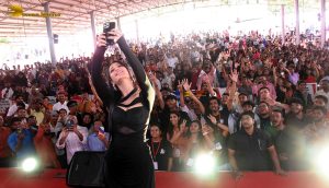 actress Shruti Haasan ravishing in a black dress speaking at an event