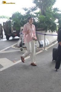 actress Sobhita Dhulipala in a pink shirt and white trousers at mumbai airport