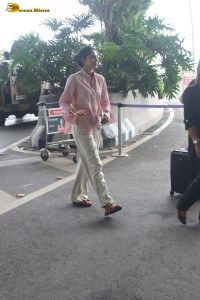 actress Sobhita Dhulipala in a pink shirt and white trousers at mumbai airport