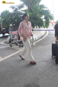 actress Sobhita Dhulipala in a pink shirt and white trousers at mumbai airport