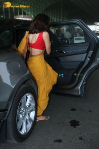 actress sobhita dhulipala wearing a yellow saree at mumbai airport