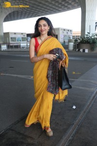 actress sobhita dhulipala wearing a yellow saree at mumbai airport