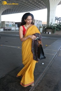 actress sobhita dhulipala wearing a yellow saree at mumbai airport