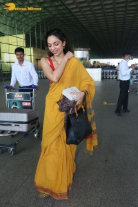 actress sobhita dhulipala wearing a yellow saree at mumbai airport