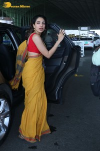 actress sobhita dhulipala wearing a yellow saree at mumbai airport