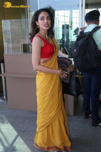 actress sobhita dhulipala wearing a yellow saree at mumbai airport