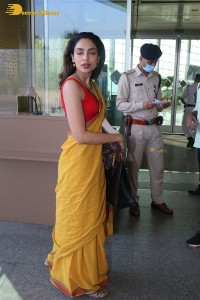 actress sobhita dhulipala wearing a yellow saree at mumbai airport