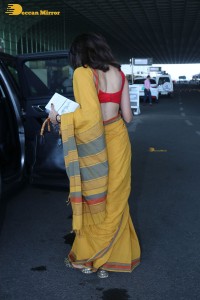 actress sobhita dhulipala wearing a yellow saree at mumbai airport