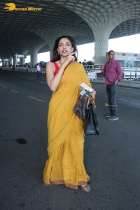 actress sobhita dhulipala wearing a yellow saree at mumbai airport