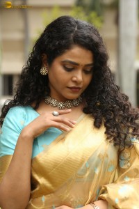 actress Sonakshi Verma in a gold color saree