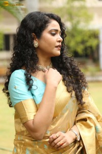 actress Sonakshi Verma in a gold color saree