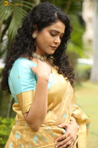 actress Sonakshi Verma in a gold color saree