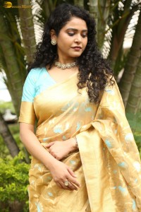 actress Sonakshi Verma in a gold color saree