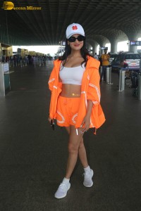 actress sonal chauhan seen at airport in orange tracks and shorts