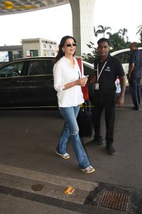 bollywood actress Sonali Bendre stylish in a white shirt and blue denim jeans