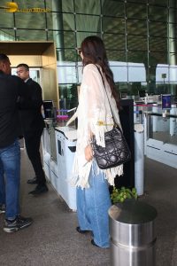 actress sonam kapoor gorgeous in a white top and flowing hair at mumbai airport
