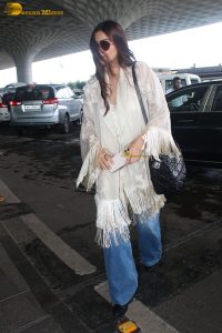 actress sonam kapoor gorgeous in a white top and flowing hair at mumbai airport