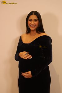 actress sonam kapoor in a black dress showing baby bump