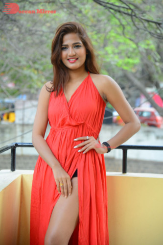 Telugu Heroine Sravani Nikki wearing a red dress and posing for photographs