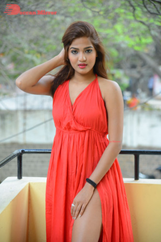 Telugu Heroine Sravani Nikki wearing a red dress and posing for photographs