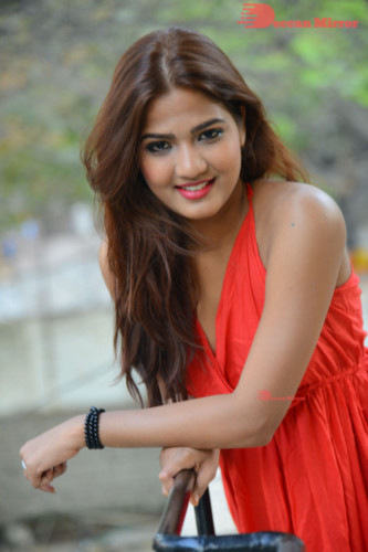 Telugu Heroine Sravani Nikki wearing a red dress and posing for photographs