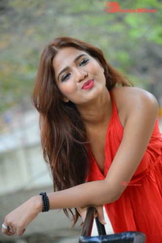 Telugu Heroine Sravani Nikki wearing a red dress and posing for photographs