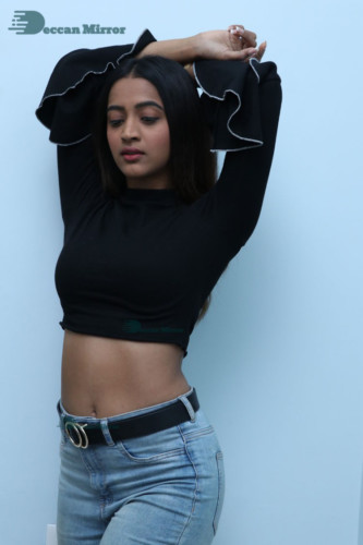 Actress Sruthi Shetty in a black top and blue jeans