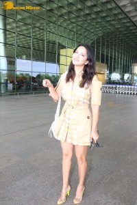 Actress Sunny Leone in a Yellow Dress at the Mumbai Airport