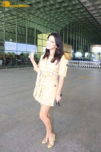 Actress Sunny Leone in a Yellow Dress at the Mumbai Airport