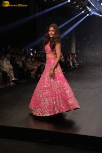 Indian actress Surbhi Chandna gorgeous in a pink lehenga choli doing a ramp walk