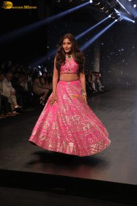 Indian actress Surbhi Chandna gorgeous in a pink lehenga choli doing a ramp walk