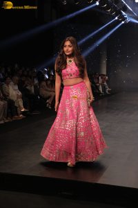 Indian actress Surbhi Chandna gorgeous in a pink lehenga choli doing a ramp walk