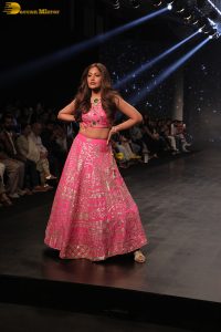 Indian actress Surbhi Chandna gorgeous in a pink lehenga choli doing a ramp walk