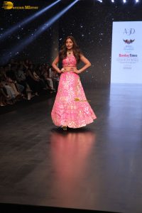 Indian actress Surbhi Chandna gorgeous in a pink lehenga choli doing a ramp walk