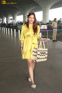 actress Surbhi Chandna beautiful in a yellow dress at mumbai airport
