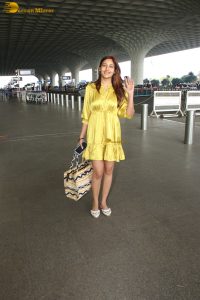 actress Surbhi Chandna beautiful in a yellow dress at mumbai airport